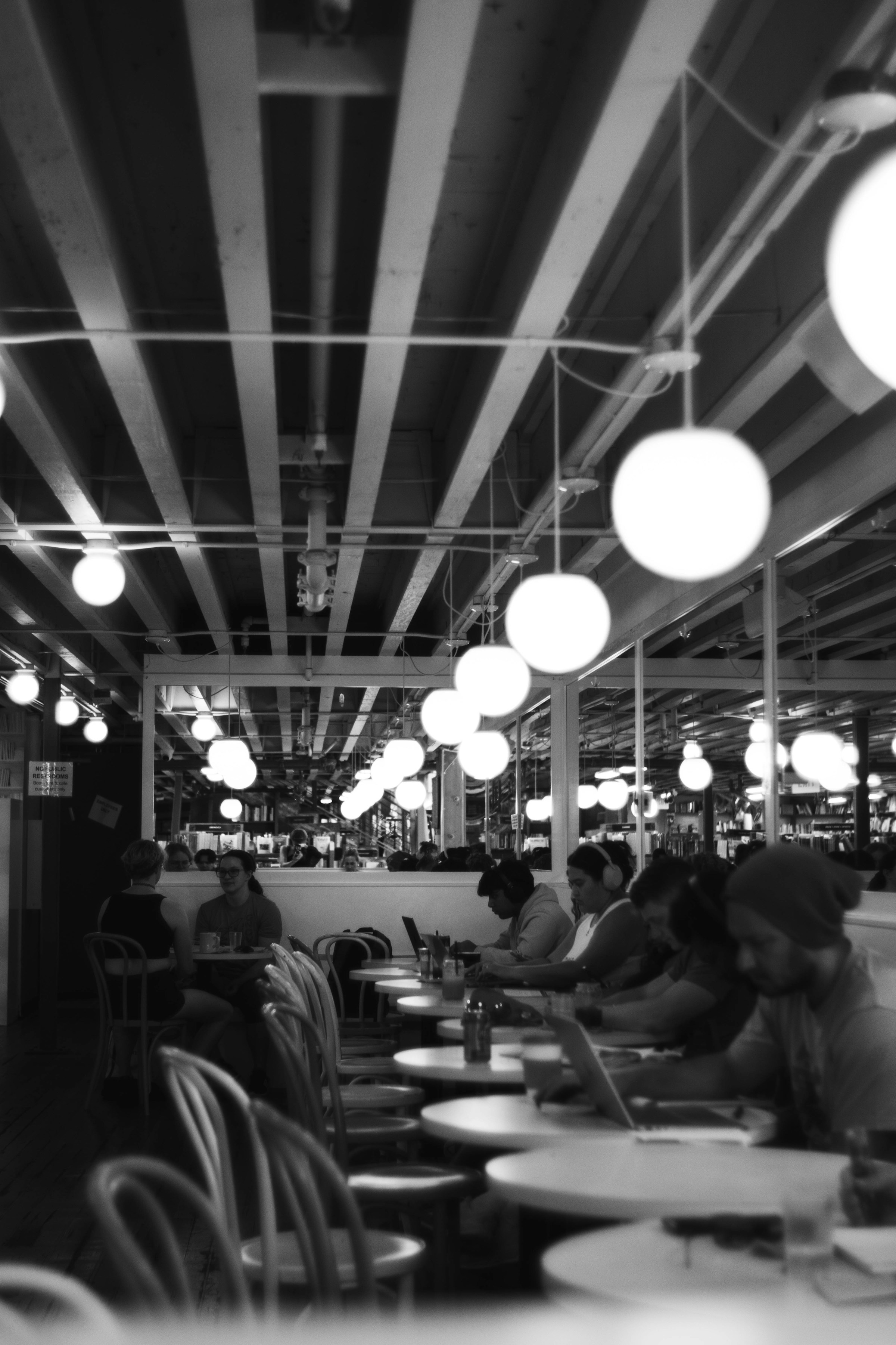 Dining room at dusk with warm pendant lamps overhead.